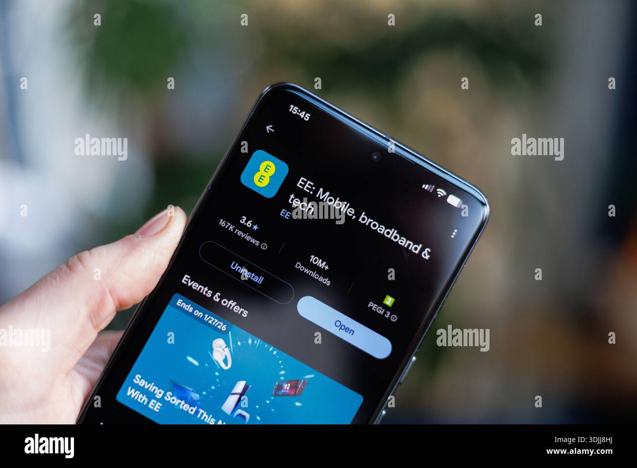 EE App on mobile phone in hand Stock Photo