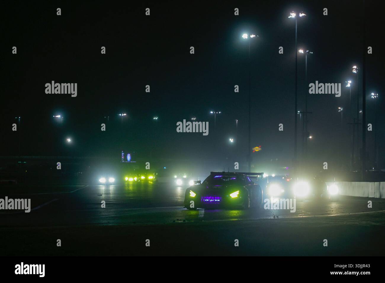DAYTONA BEACH, FL - JANUARY 24: Cars race during night during the Rolex ...