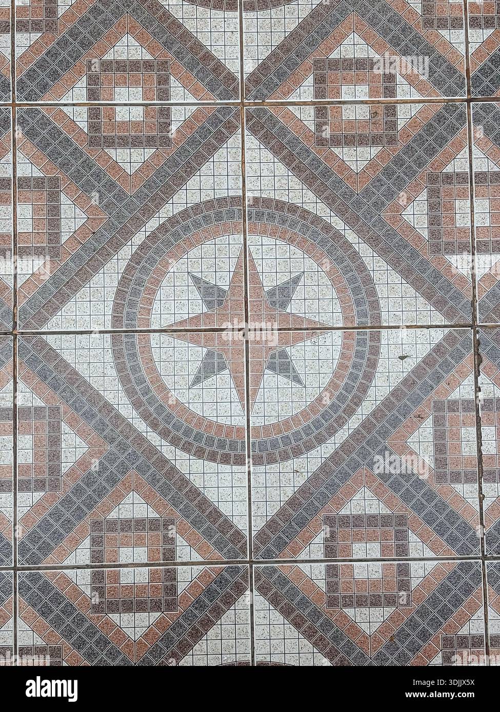 Ceramic floor tiles. Tiling, pavement, surface covering. Repeating geometric pattern with star design. Background texture. Stock Photo