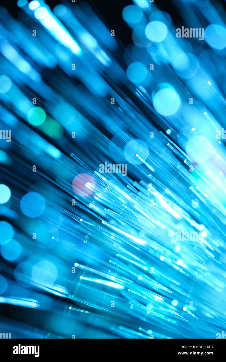 Optical fibres dinamic flying from deep on technology abstract background Stock Photo