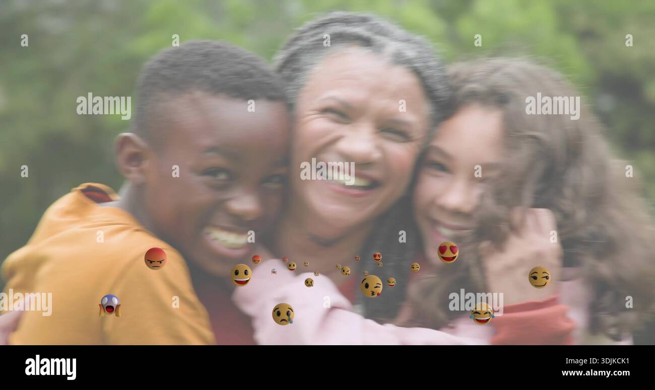 Hug Leaning Smiling mother in red top and children leaning into hug at park ...