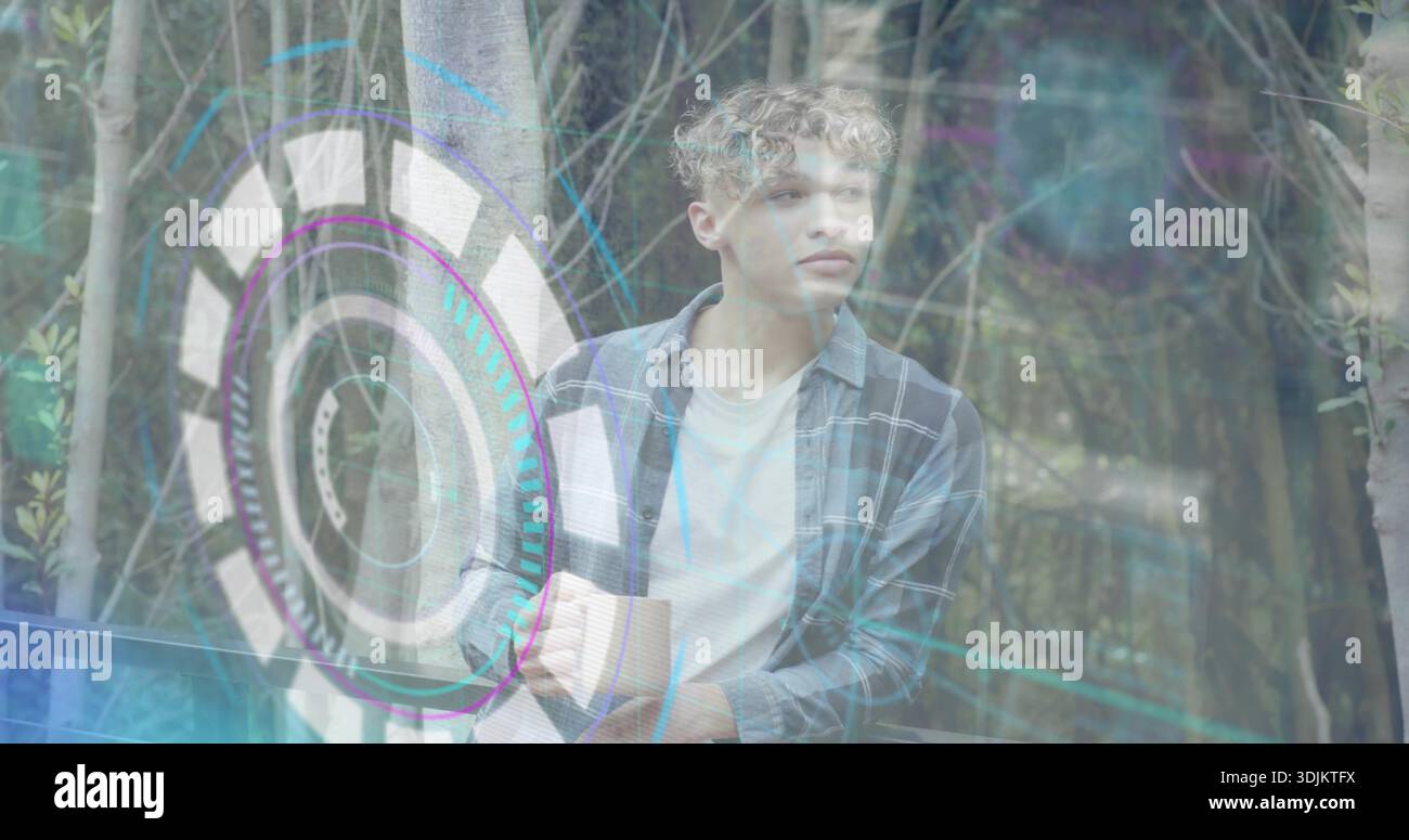 Leaning male in plaid shirt on deck among thin trunks, touching holographic interface, copy space Stock Photo