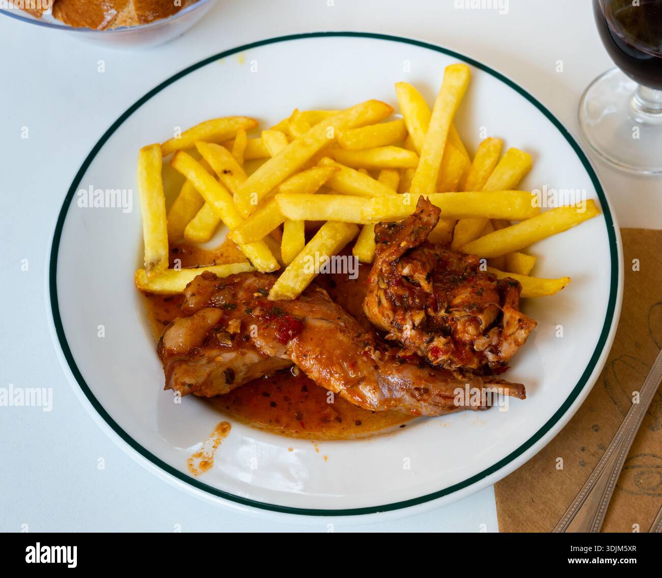 Braised rabbit served with potato garnish Stock Photo