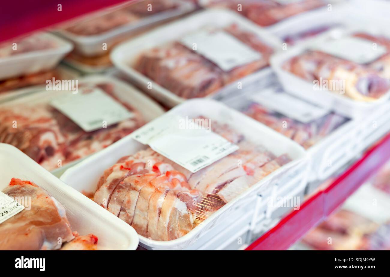 Packaged mutton meat laid out on display shelves of butcher store Stock ...