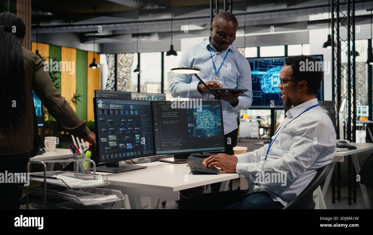 Smiling programmers working in AI startup train predictive models for language processing tasks. Cheerful IT professionals use machine learning technical expertise for complex tasks, camera A Stock Photo