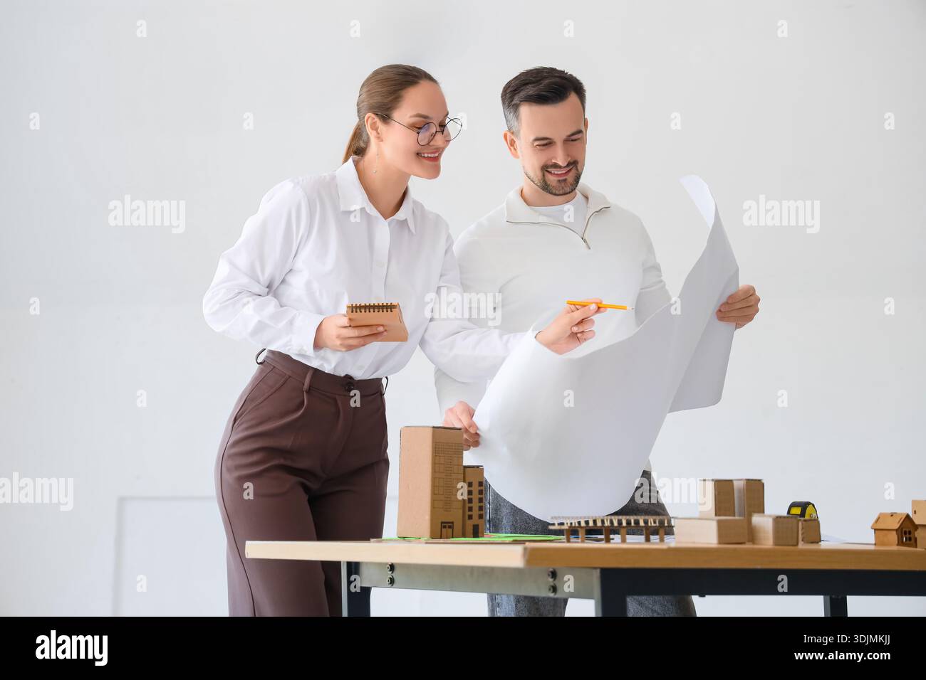 Young architects working with house plan in office Stock Photo