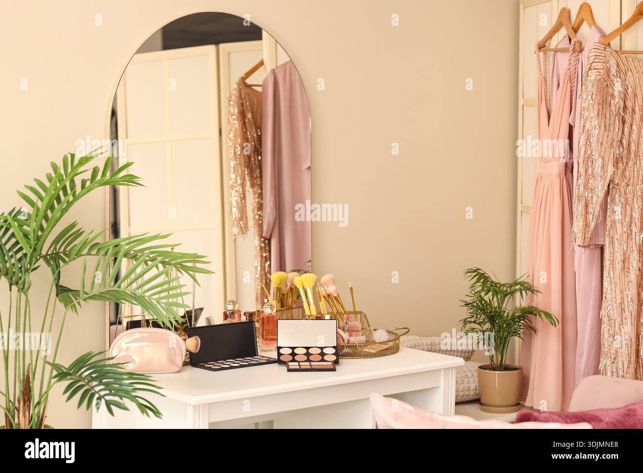 Makeup products on table in dressing room Stock Photo