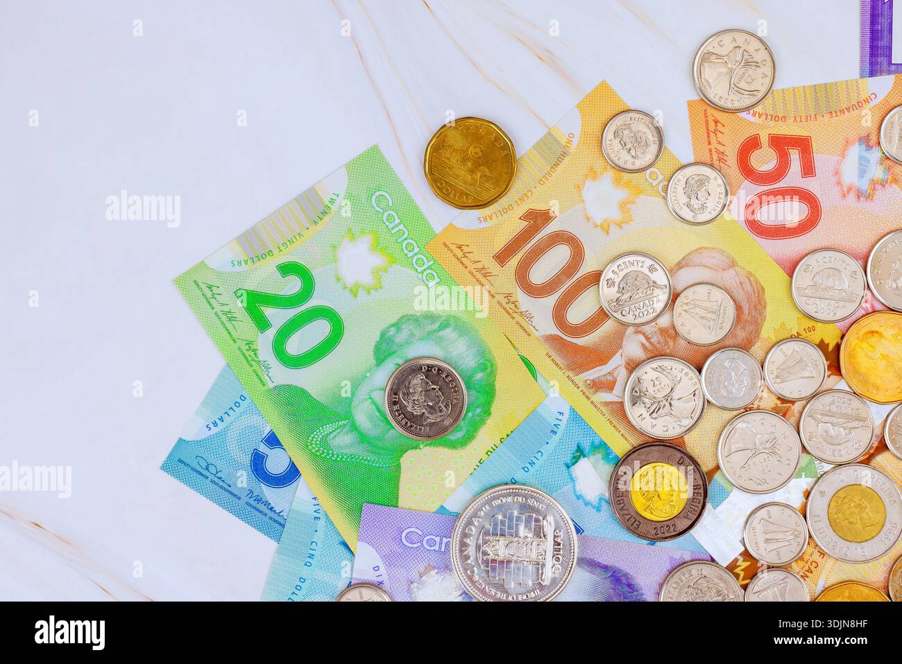 Canadian Banknotes Design Several Canadian banknotes, coins are spread out on flat surface their ...