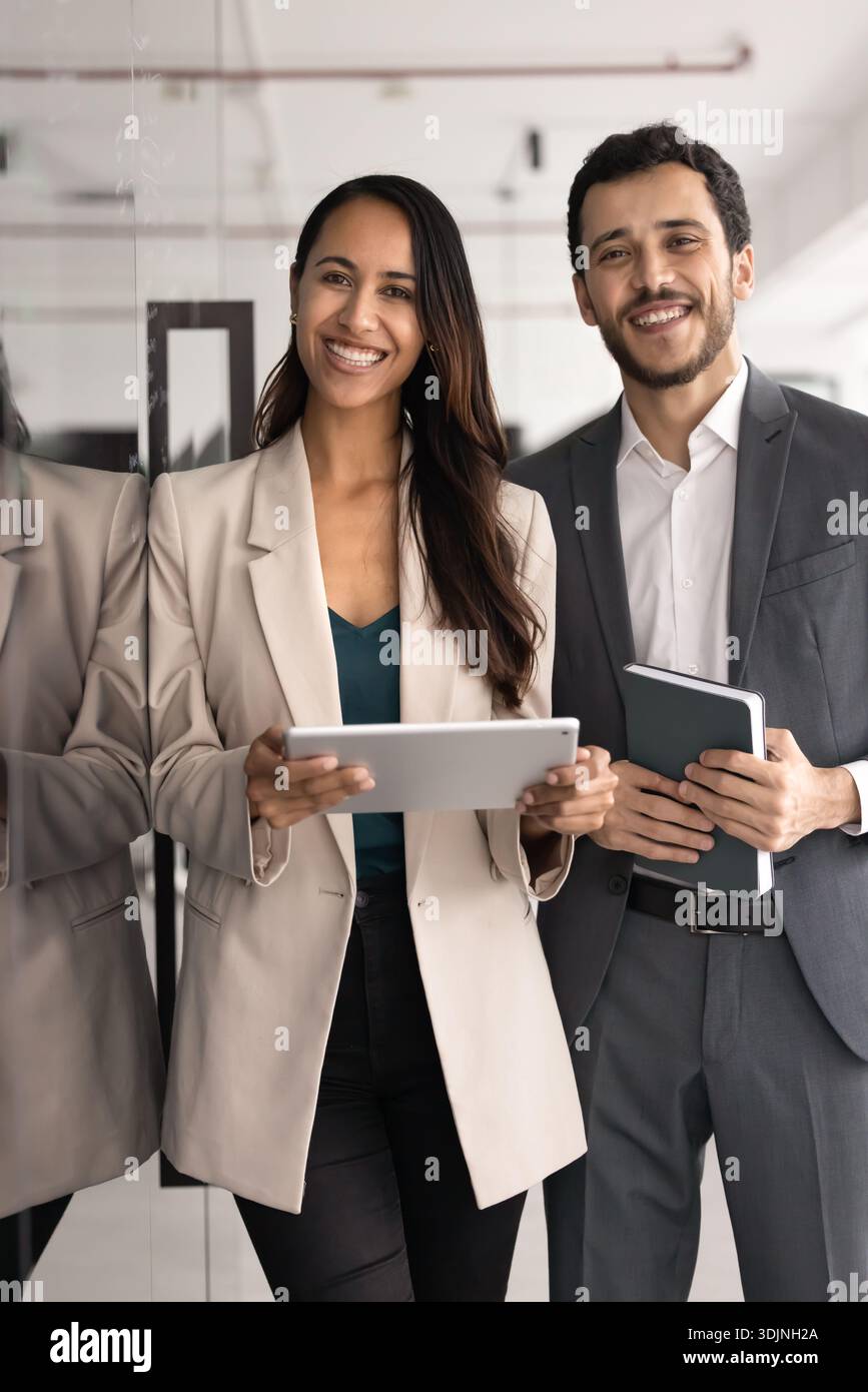 Happy young, professional multiethnic teammates posing in workspace Stock Photo