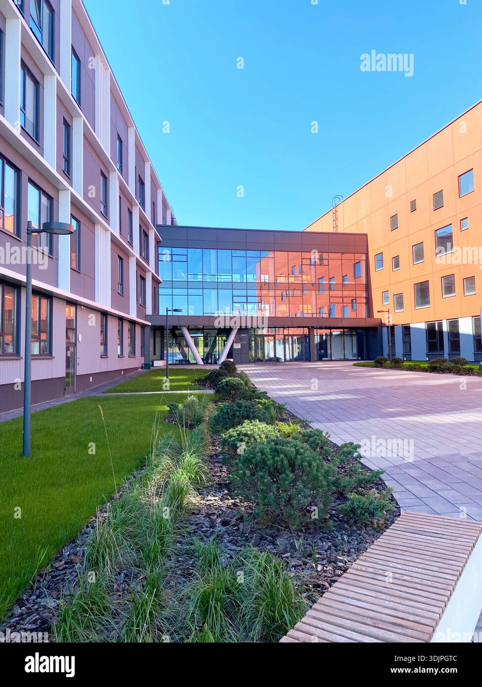 Modern school building features a large glass entrance and landscaped ...