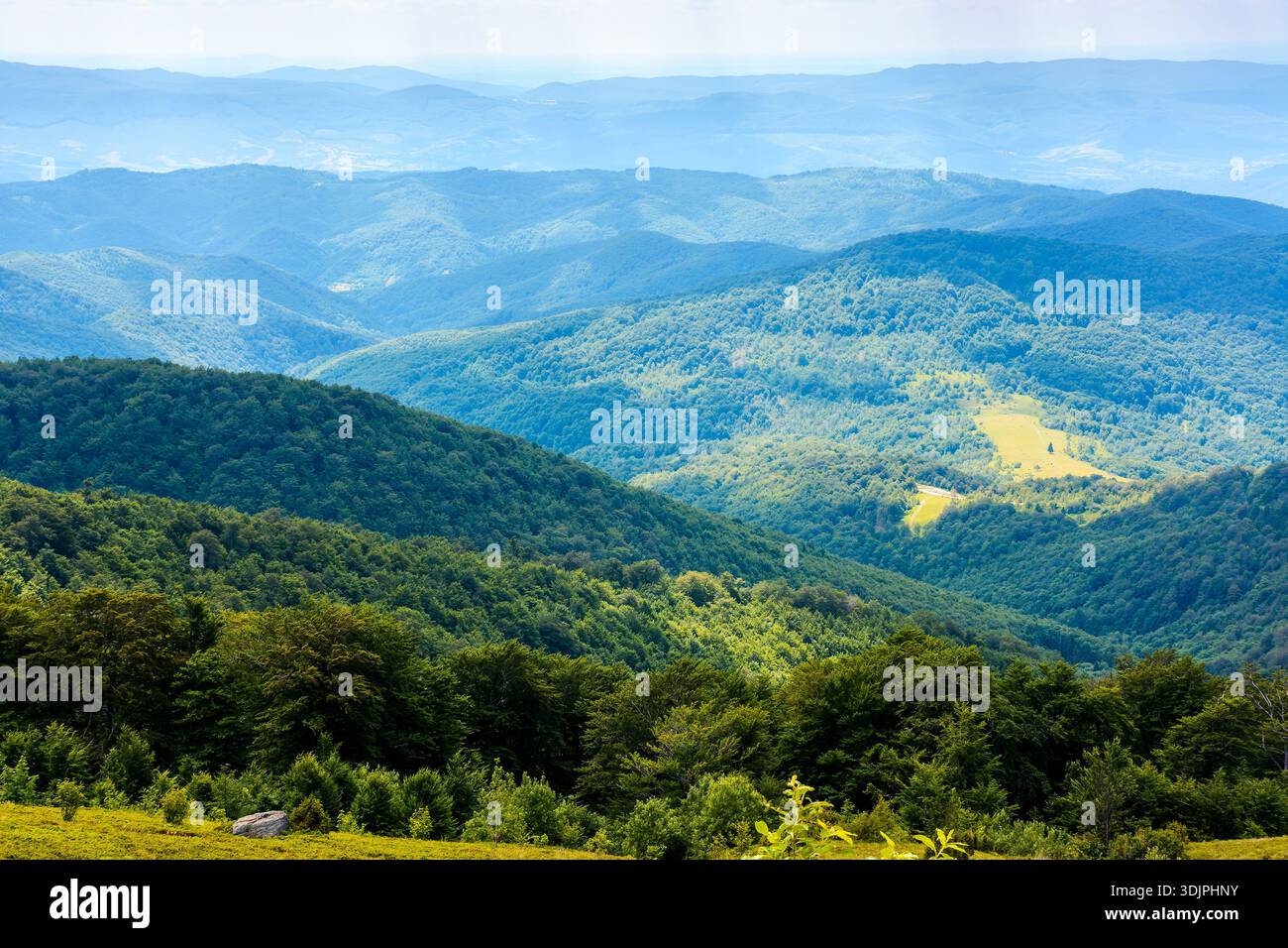 mountain landscape with rolling hills. summer countryside scenery of ukraine with view in to the distant valley and green forested slopes on a sunny f Stock Photo