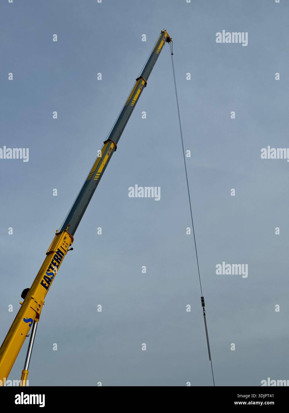 Kesgrave, Suffolk - 28 January 2026: Construction of a new Co Op supermarket in progess in the Grange Farm area. Tall crane looms over nearby houses. - Smartphone Captured Stock Image