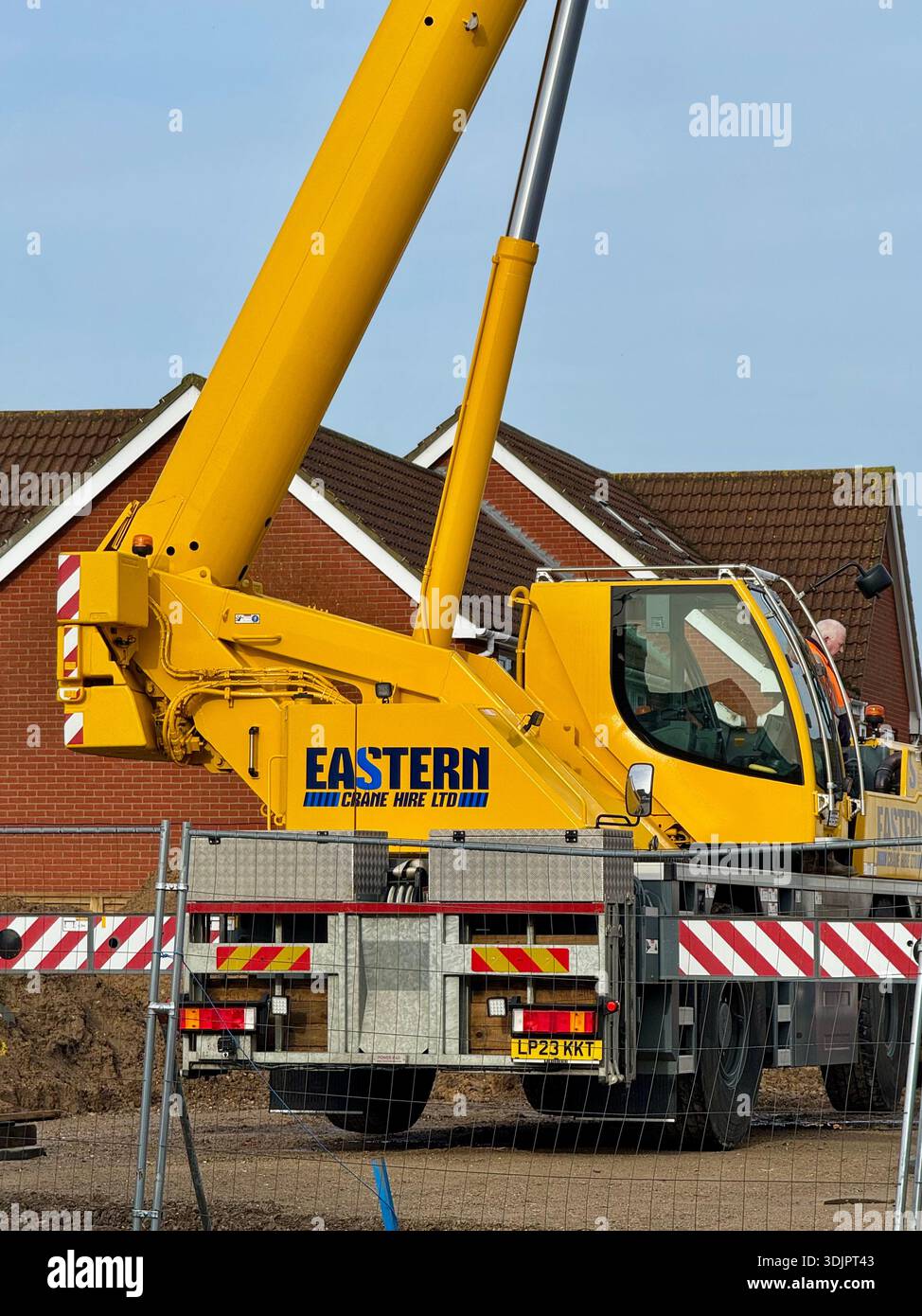 Kesgrave, Suffolk - 28 January 2026: Construction of a new Co Op supermarket in progess in the Grange Farm area. Tall crane looms over nearby houses. - Smartphone Captured Stock Image