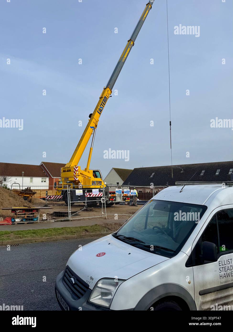 Kesgrave, Suffolk - 28 January 2026: Construction of a new Co Op supermarket in progess in the Grange Farm area. Tall crane looms over nearby houses. - Smartphone Captured Stock Image