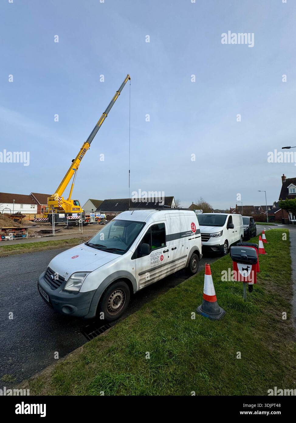Kesgrave, Suffolk - 28 January 2026: Construction of a new Co Op supermarket in progess in the Grange Farm area. Tall crane looms over nearby houses. - Smartphone Captured Stock Image