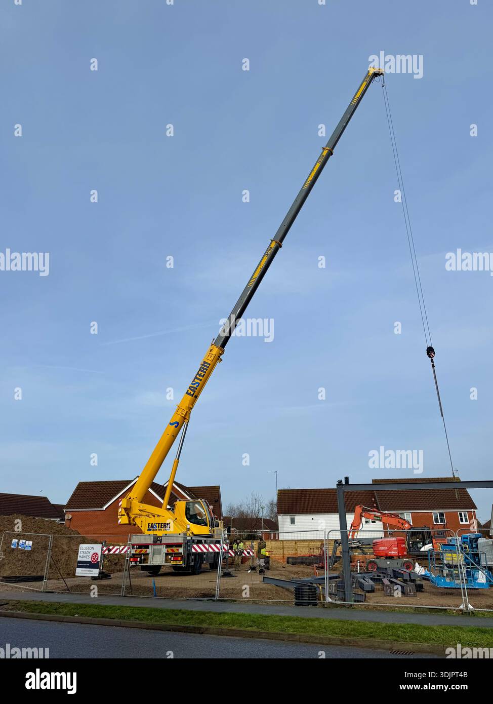 Kesgrave, Suffolk - 28 January 2026: Construction of a new Co Op supermarket in progess in the Grange Farm area. Tall crane looms over nearby houses. - Smartphone Captured Stock Image