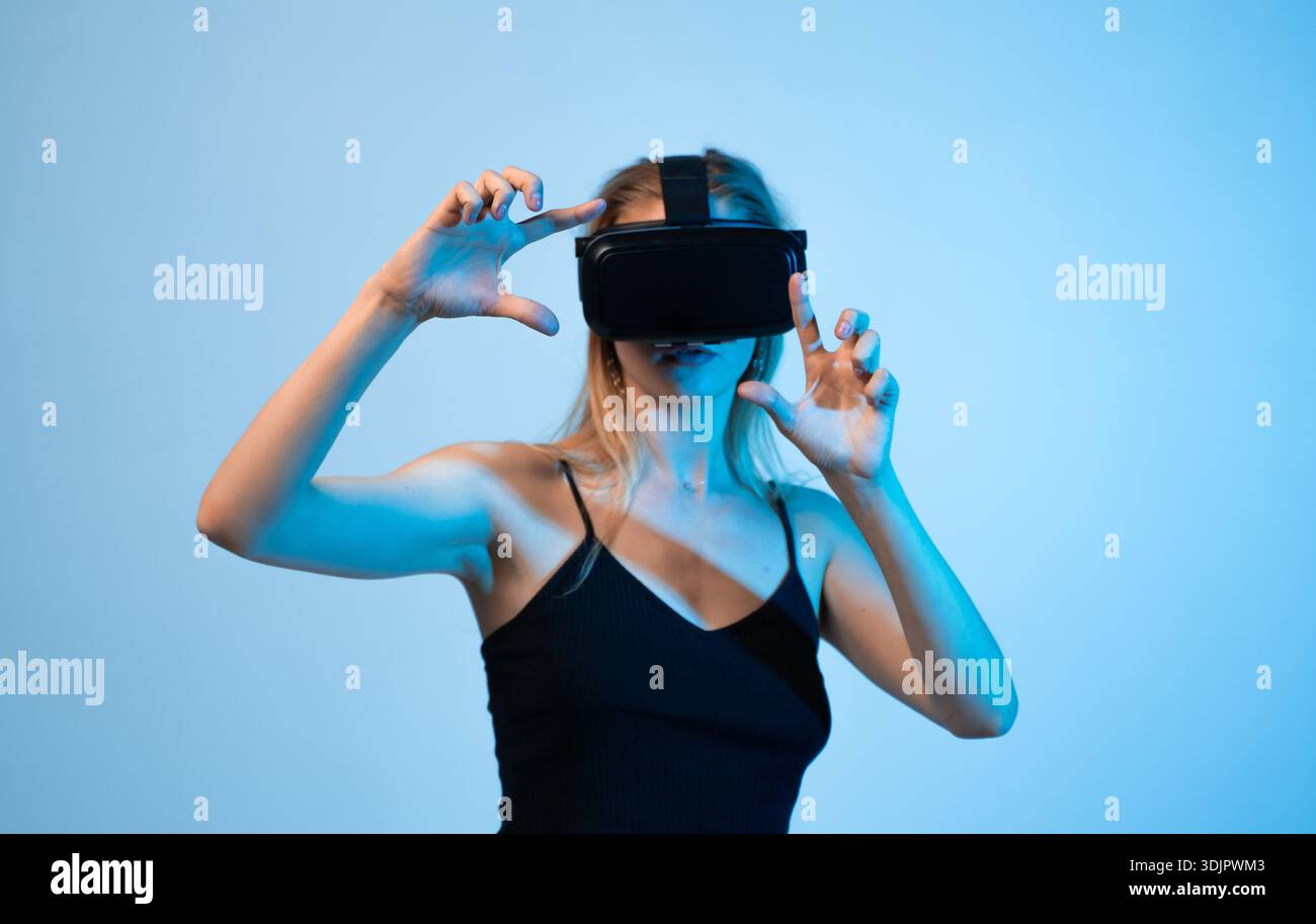 Female engineer interacting with virtual interface using VR headset, high technology innovation and immersive digital experience Stock Photo