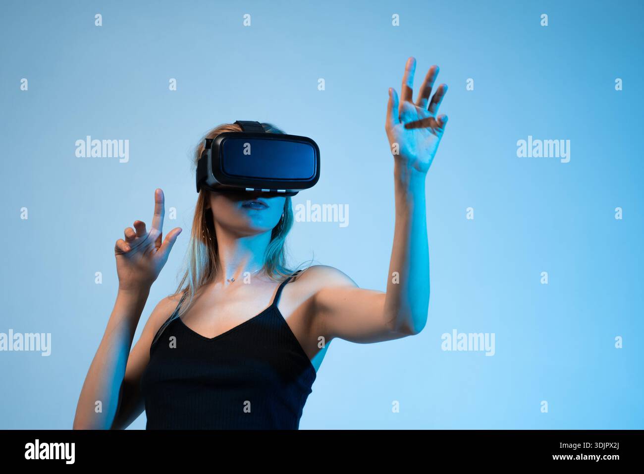 Virtual reality interaction with woman using VR headset, immersive experience and modern digital technology Stock Photo