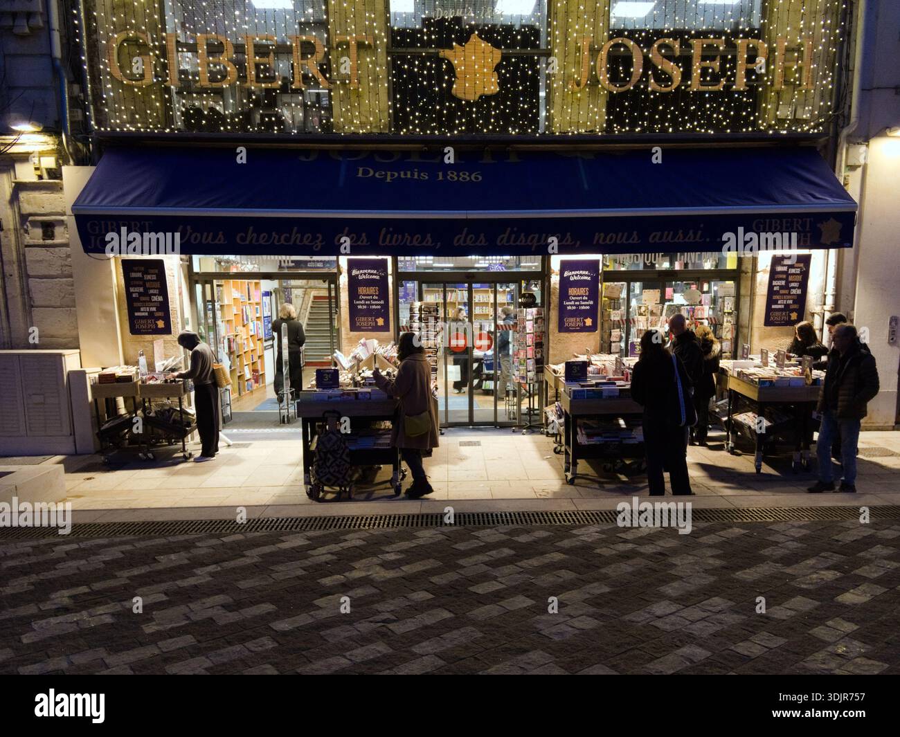 Bookshop with books outdoors open late in the evening at the Place des Martyrs in the historic city center of Montpellier, France Stock Photo
