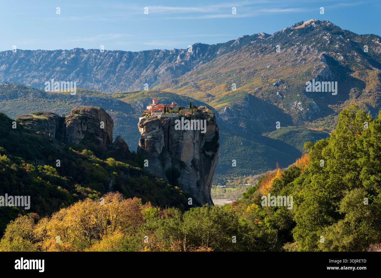 Monastery of the Holy Trinity perched on a dramatic rock pillar in Meteora with mountain landscape in autumn, Thessaly, Greece Stock Photo