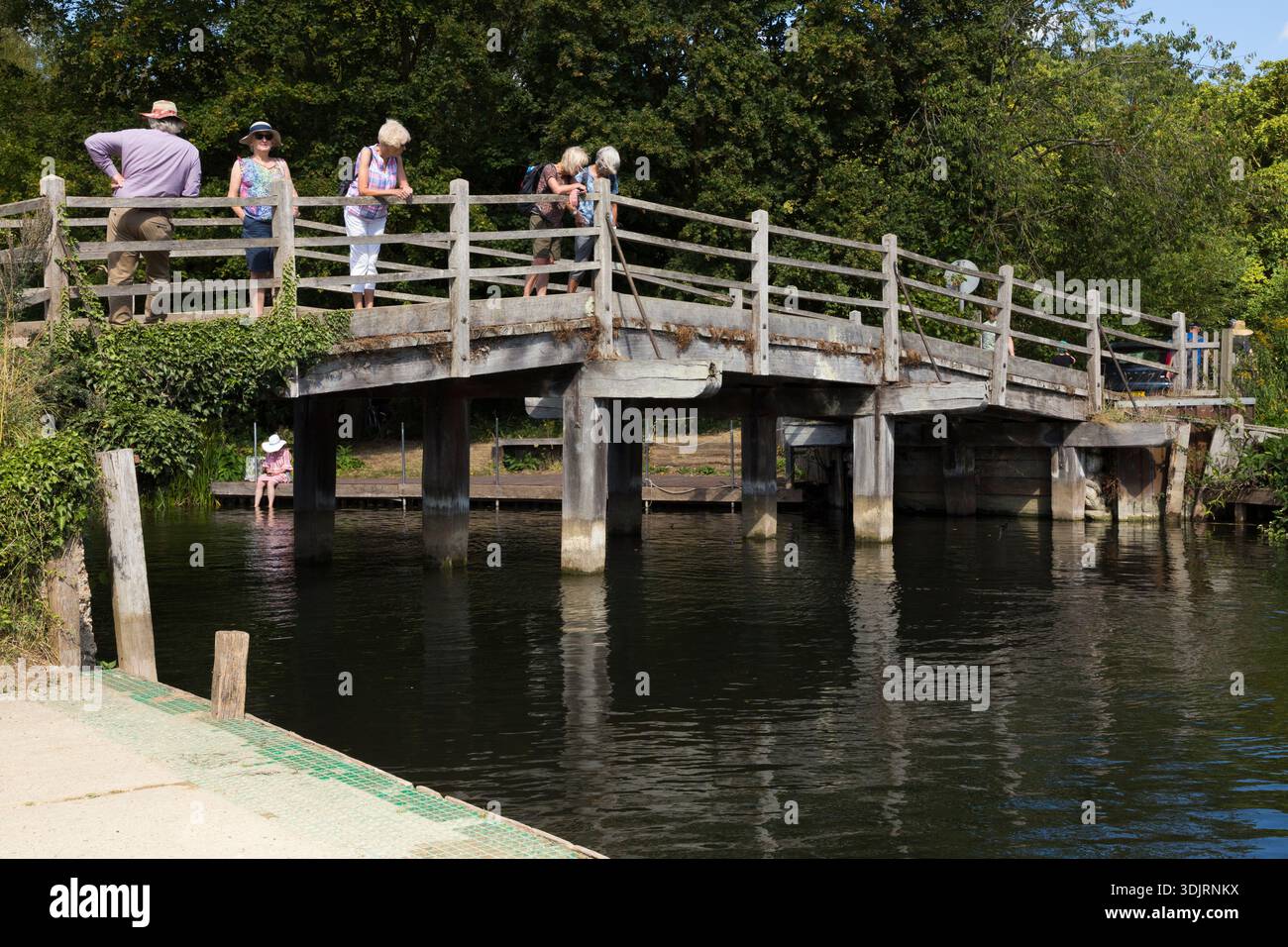 Tourist crossing traditional site of bridge over the river Stour taken ...