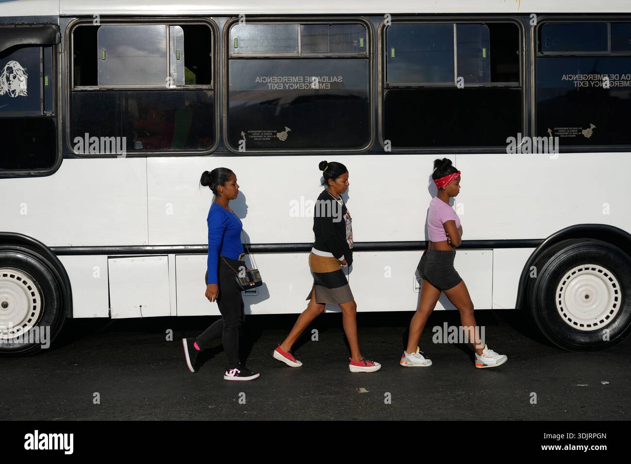 People walk by a bus during rush hour in Caracas, Venezuela, Wednesday ...