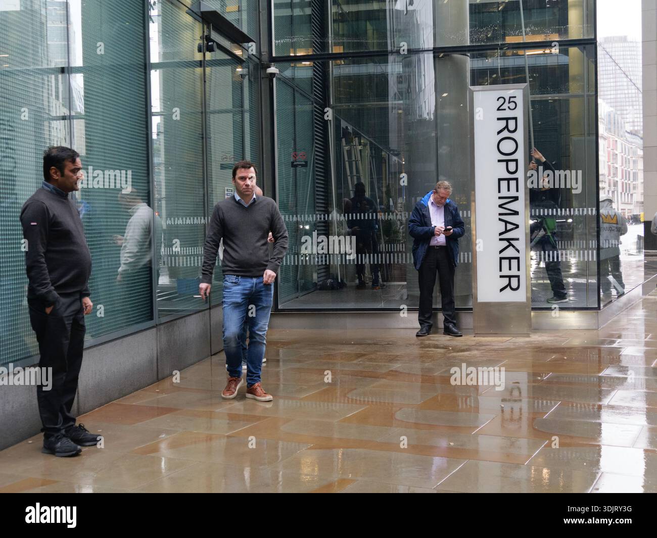Smokers congregate outside the 25 Ropemaker Place office building in ...