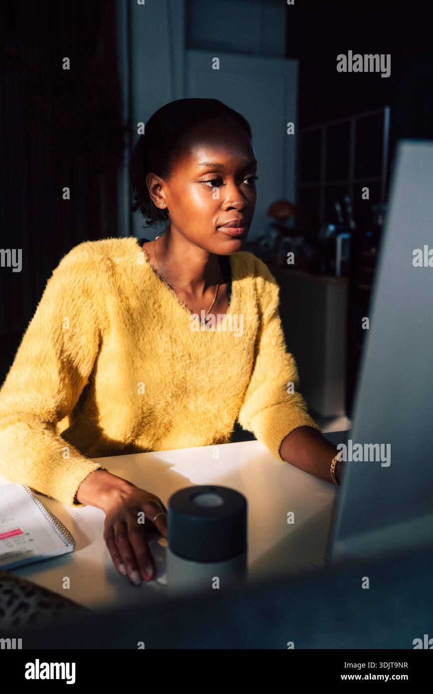 Focused female young programmer working on computer in office Stock Photo
