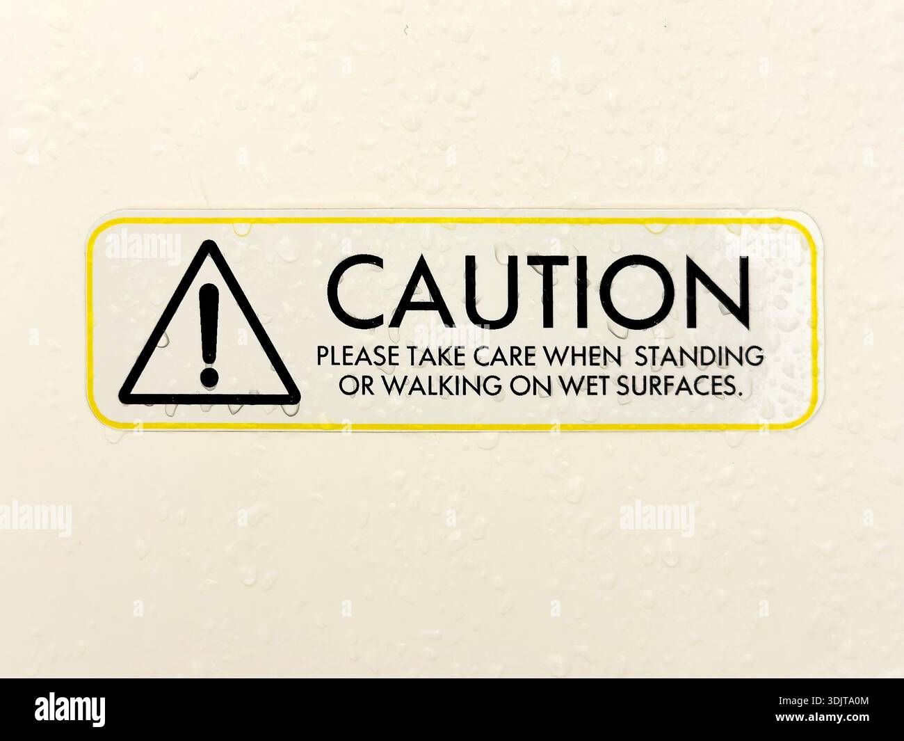 Safety sign indicating caution for wet surfaces, reminding individuals to take care when standing or walking in hotel shower room - Smartphone Captured Stock Image