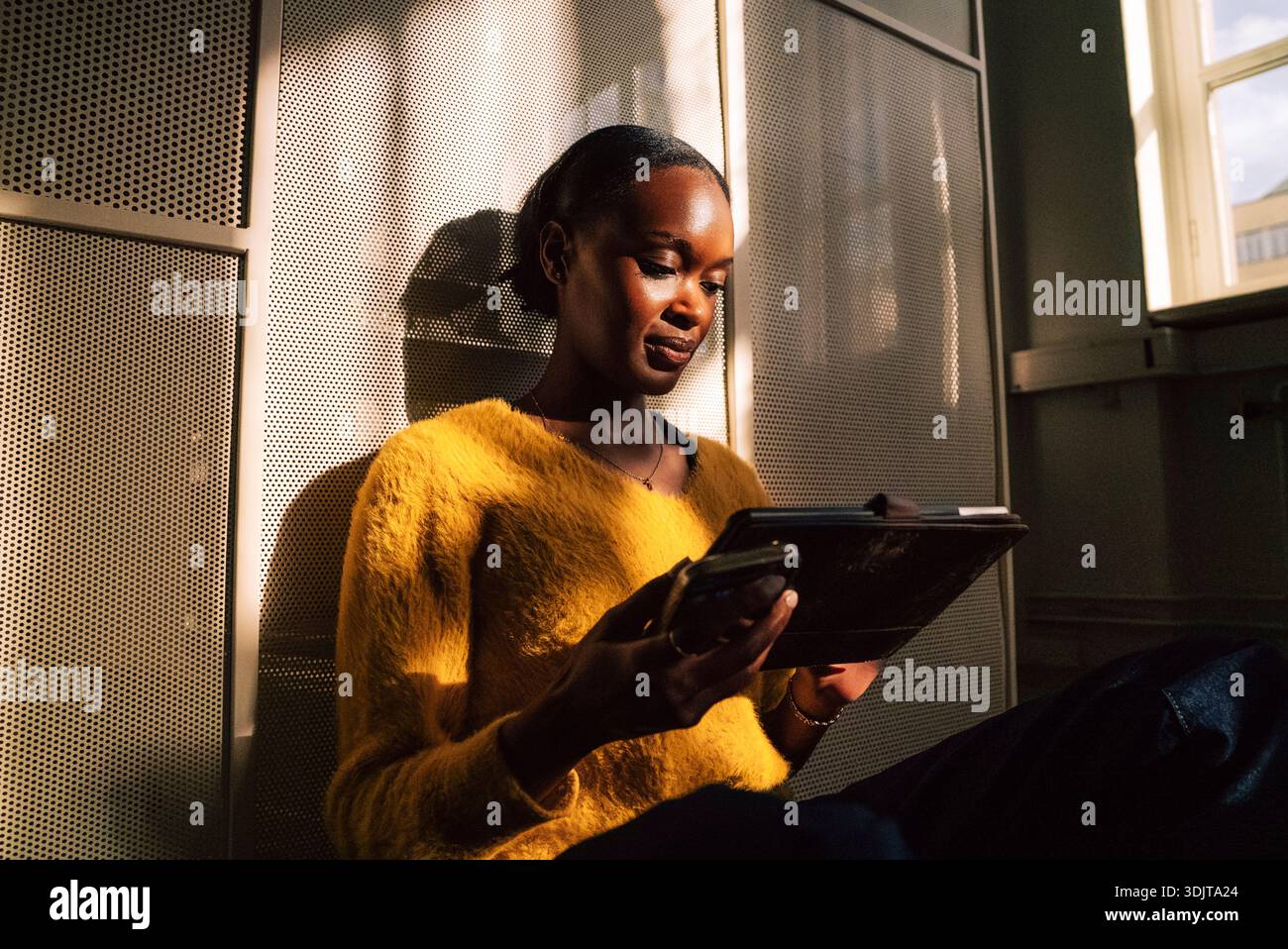 Female business expert using tablet PC while sitting in office Stock Photo