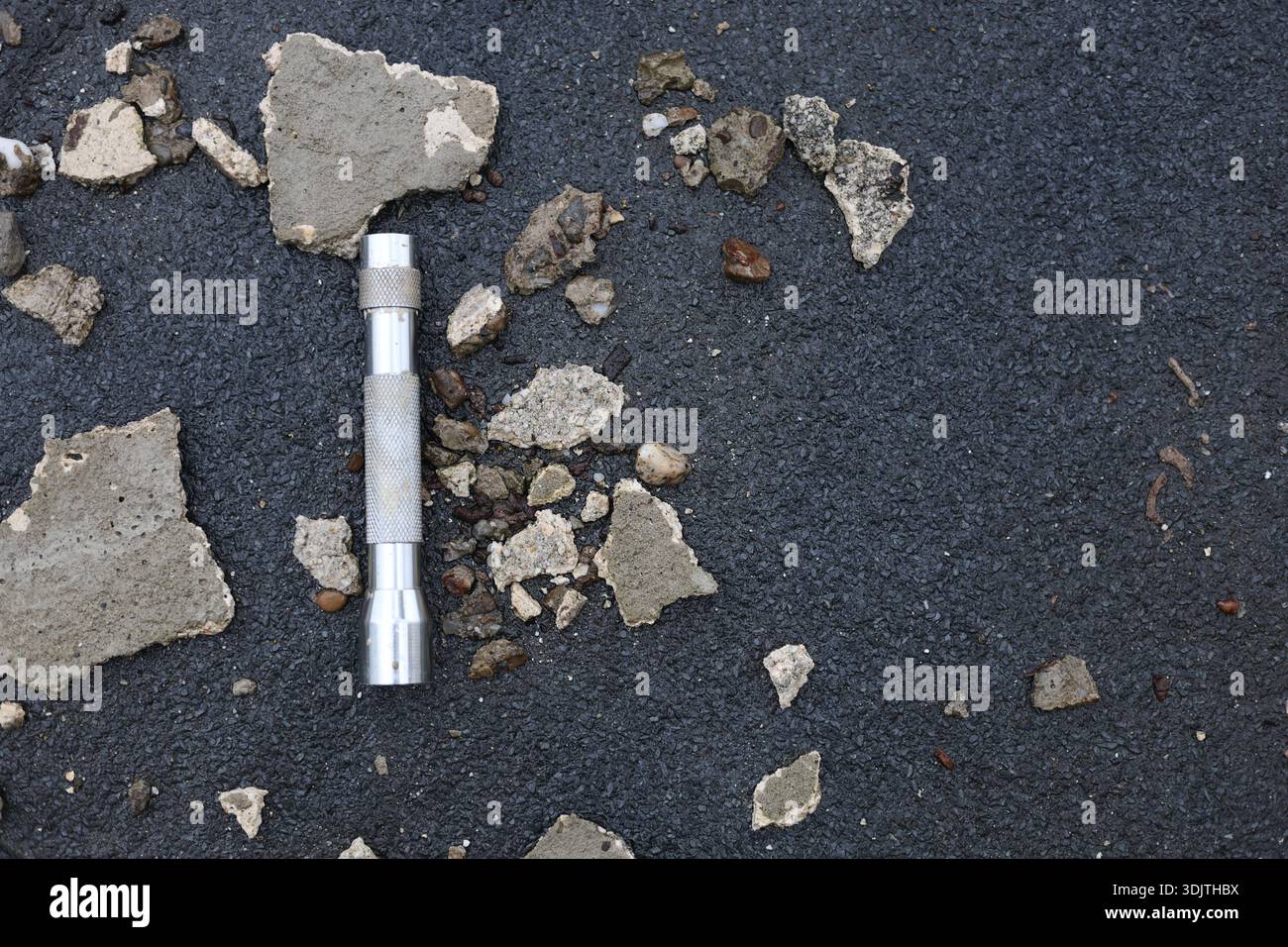 A small metallic used and dirty flashlight Stock Photo