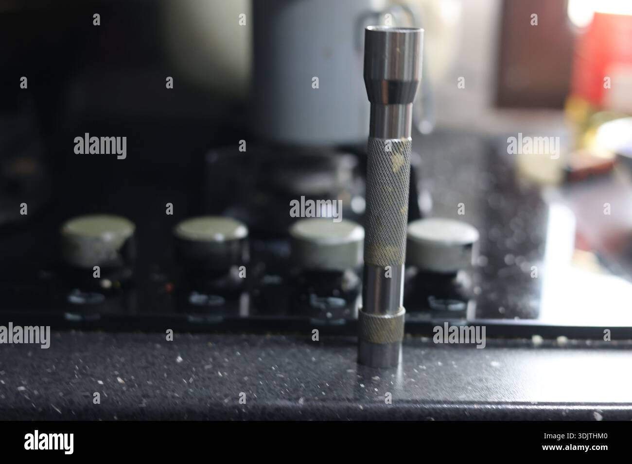 A small metallic used and dirty flashlight Stock Photo