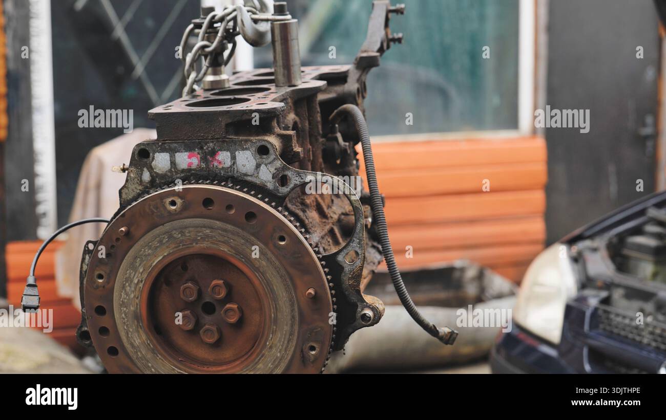 Car engine block on chain hoist undergoing repair service Stock Photo ...