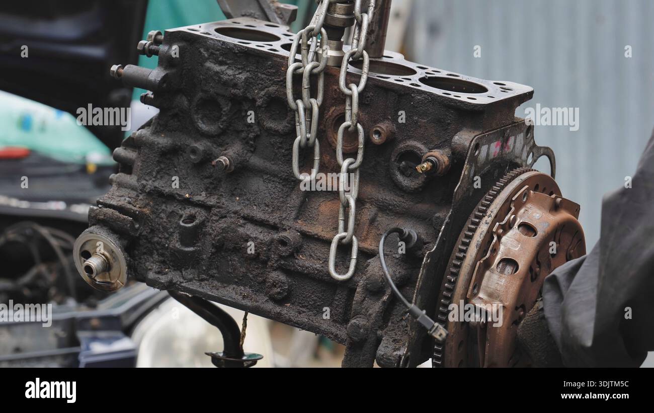 Mechanic repairing car engine at auto service station Stock Photo - Alamy