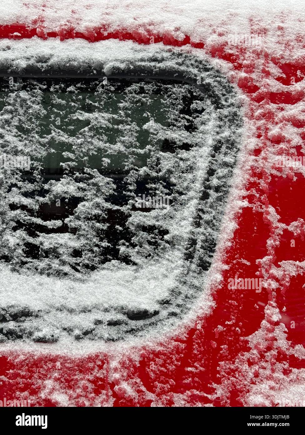 Detail of a red car covered in snow - Smartphone Captured Stock Image