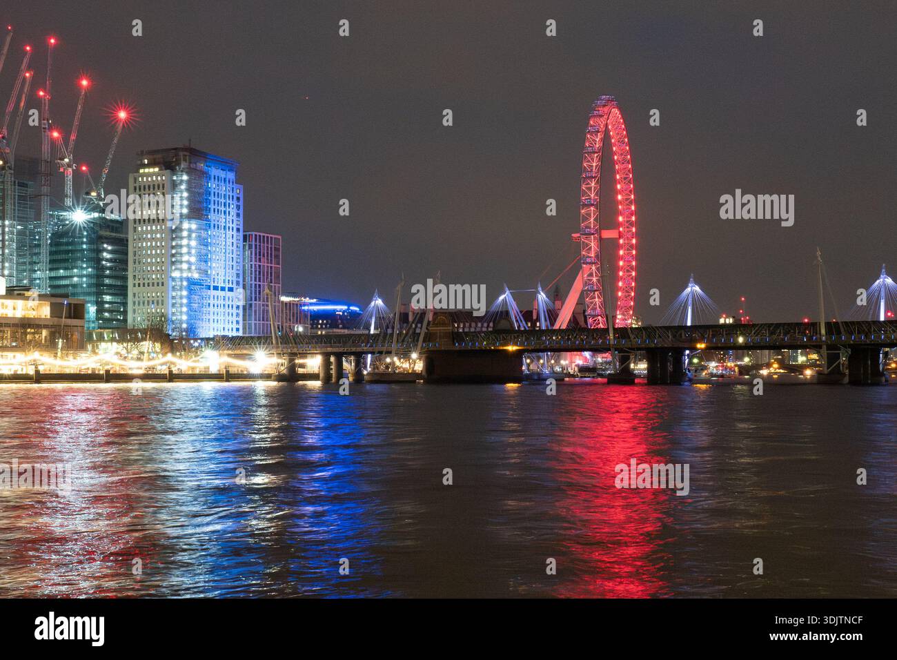 The River Thames and embankment at night with the London Eye , Shell ...