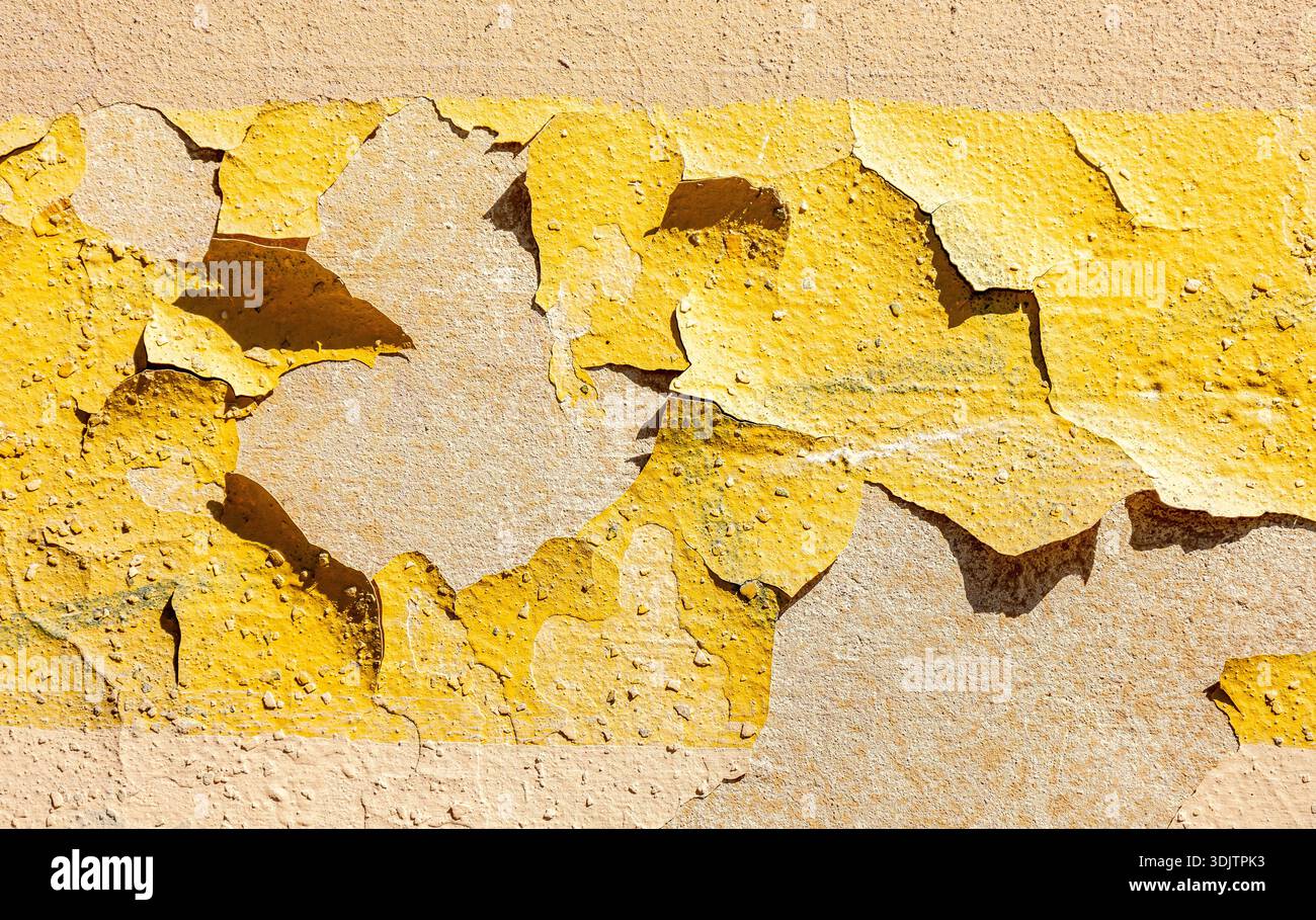 Cracked grunge yellow stone wall as background texture Stock Photo