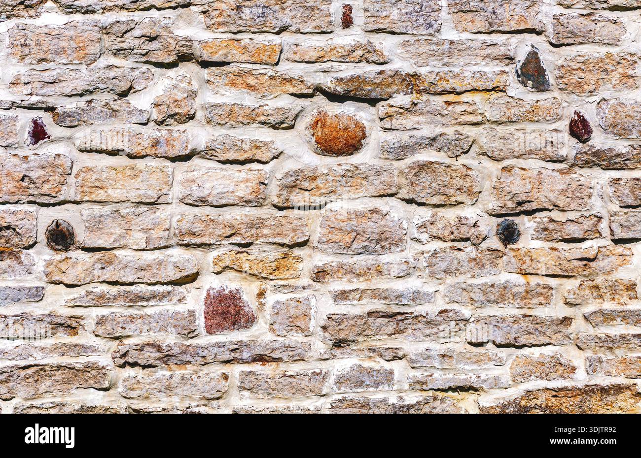 Weathered grey stone wall as creative background texture Stock Photo