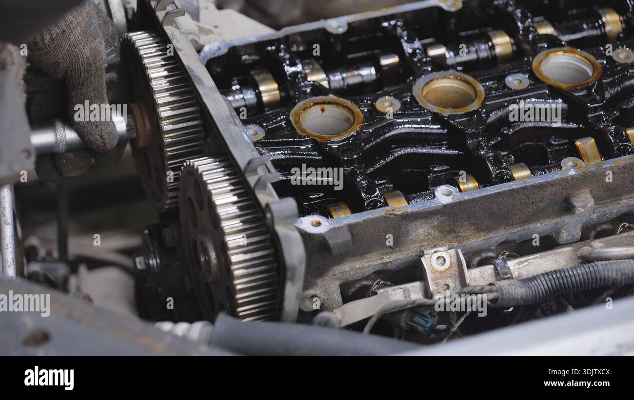 Mechanic hand repairing car engine components in service station Stock ...