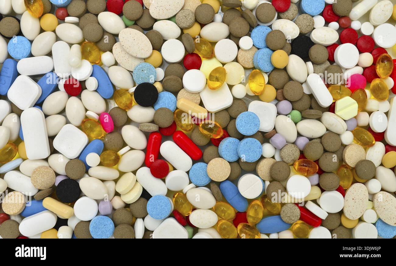 Various colors pills texture background drugs pattern Stock Photo
