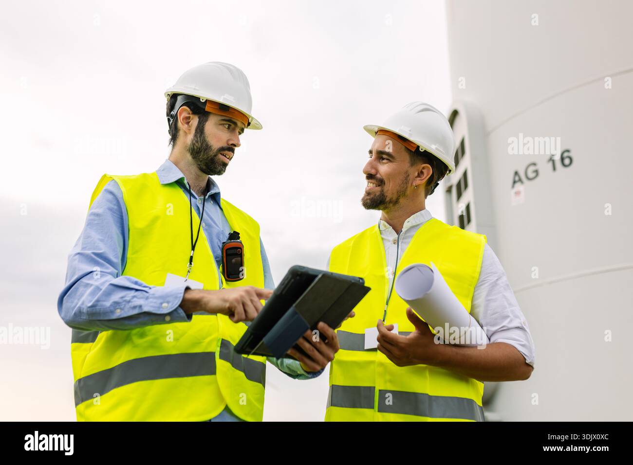 Engineers discussing wind turbine project plan Stock Photo