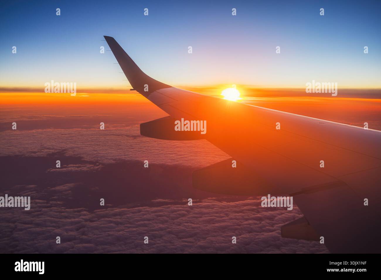 Aerial view from the plane over fluffy clouds. Stock Photo
