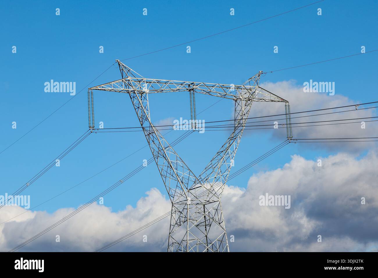 High voltage electricity transmission pylon with power lines against ...
