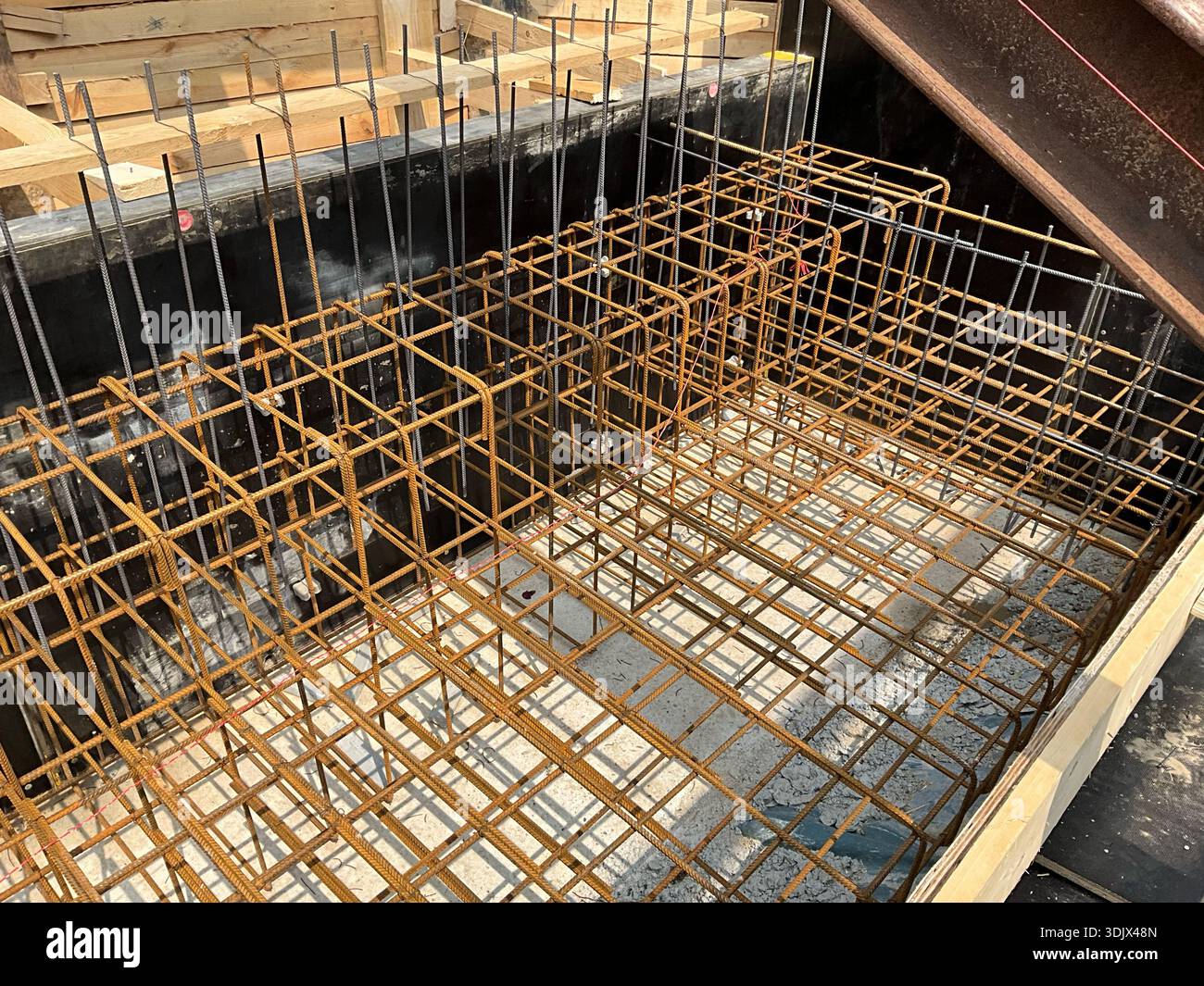 Detailed view of steel rebar reinforcement installed inside wooden ...