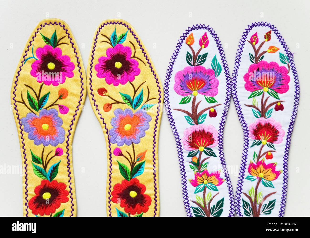 Traditional Chinese hand-embroidered insoles featuring vibrant floral motifs and folk art needlework. Stock Photo