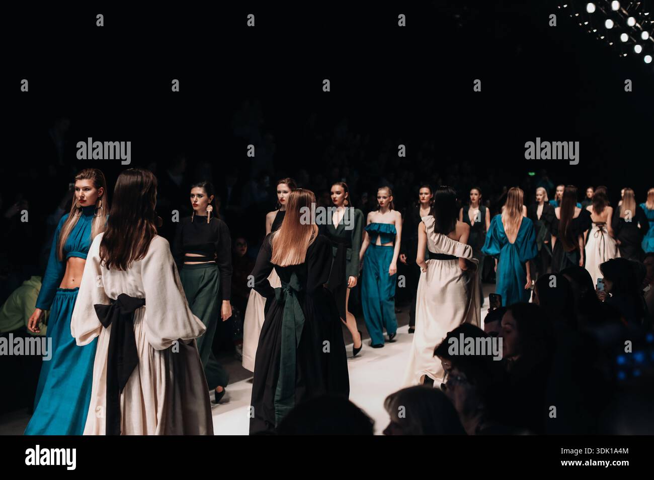 Luxury women's dresses, bohemian cloth and design. Fashion models walking  in a row the finale runway during Fashion Week Stock Photo - Alamy