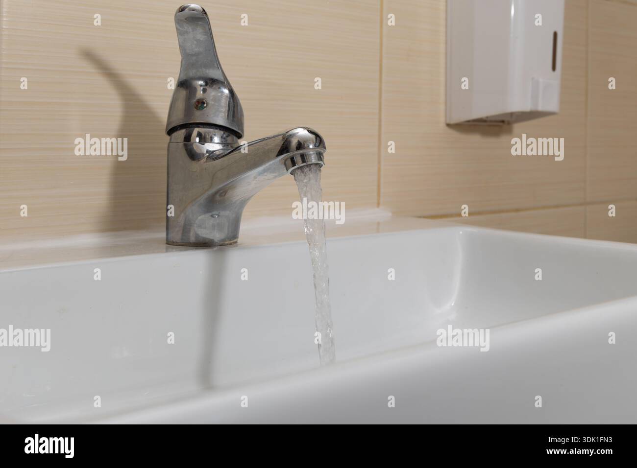 Water leaking from the tap into the sink, dripping clean water, data ...