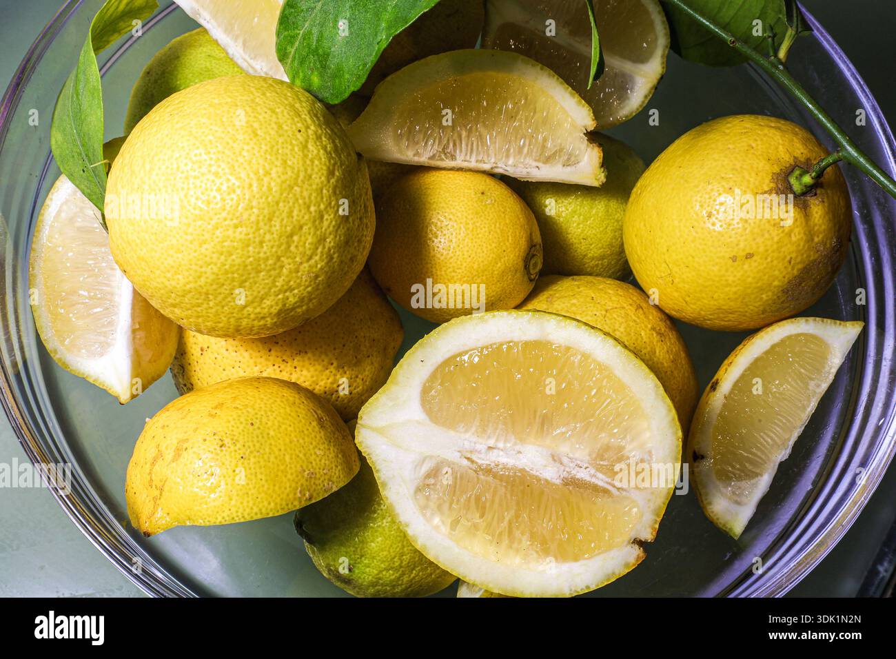 Rustic food-themed composition of citrus fruits in a glass bowl, ideal for nutrition, healthy eating, or culinary visuals. Stock Photo