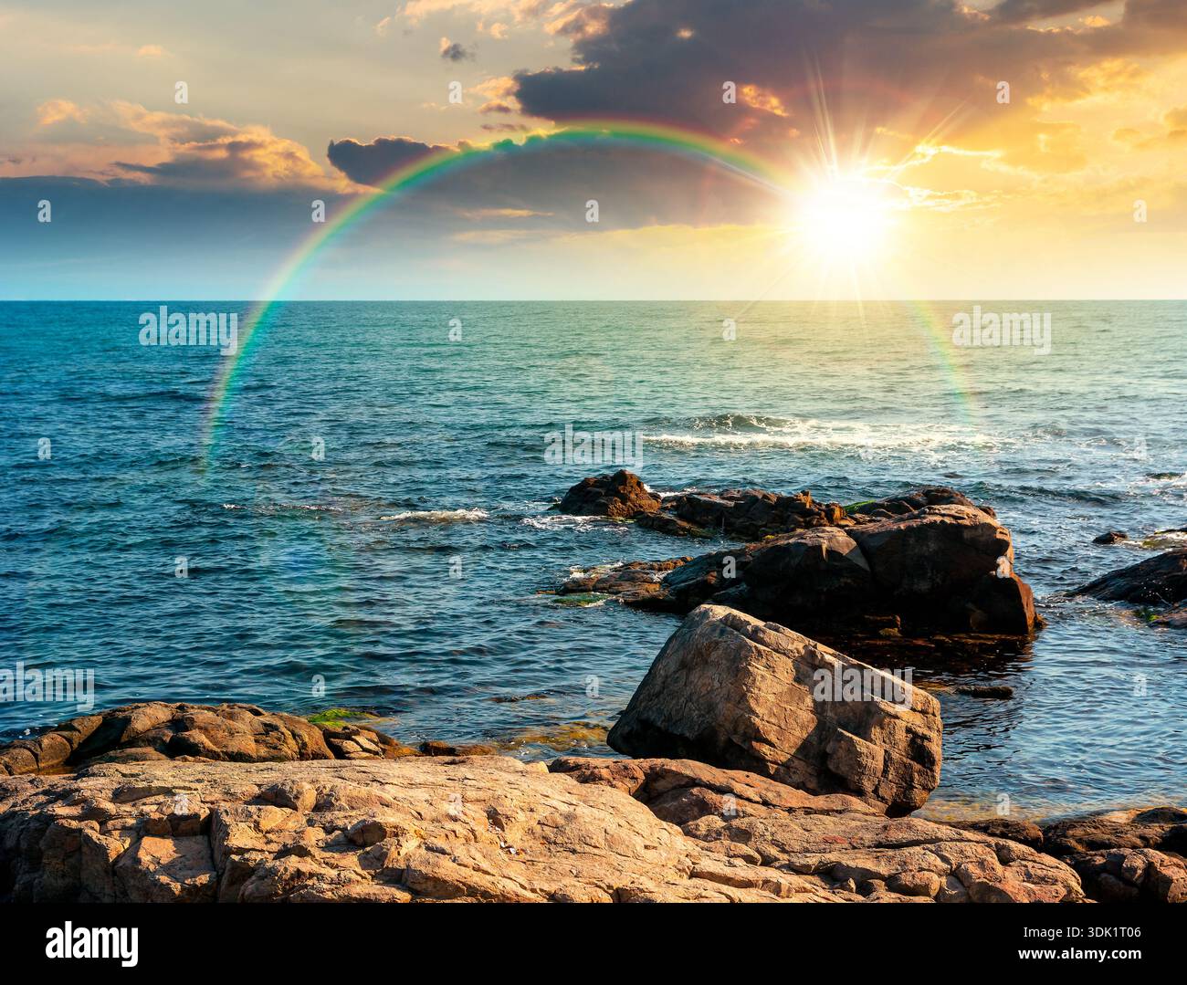 rocky shore of the sea coast under blue sky at sunset. beautiful view of coastal scene in evening light. resort scenery during vacation season in summ Stock Photo