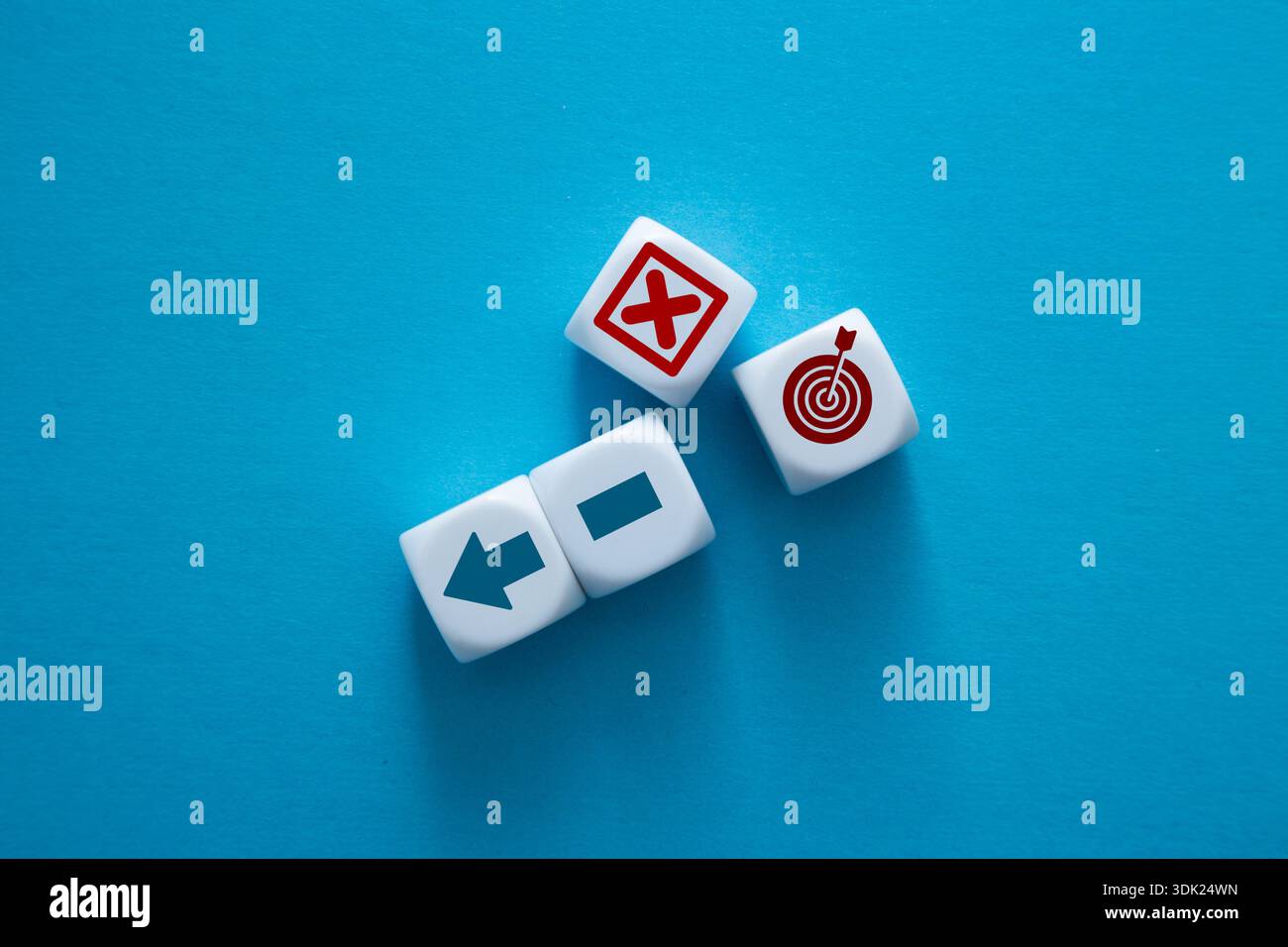 Dices representing direction, error, and target on a blue background Stock Photo